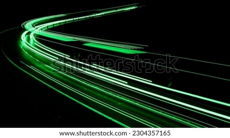green car lights at night. long exposure Royalty-Free Stock Photo #2304357165