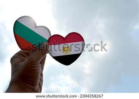 Hand holds a heart Shape Bulgaria and Egypt flag, love between two countries
