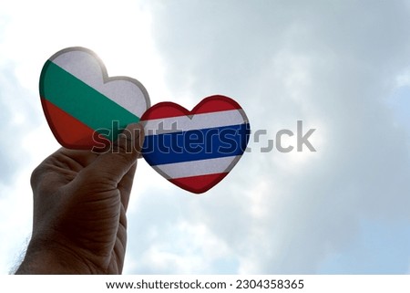 Hand holds a heart Shape Bulgaria and Thailand flag, love between two countries