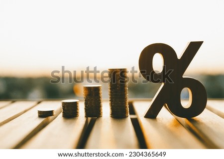 Percentage model with coins stack. Concepts of the banking system, rising interest rates, inflation, deflation, and savings.	 Royalty-Free Stock Photo #2304365649