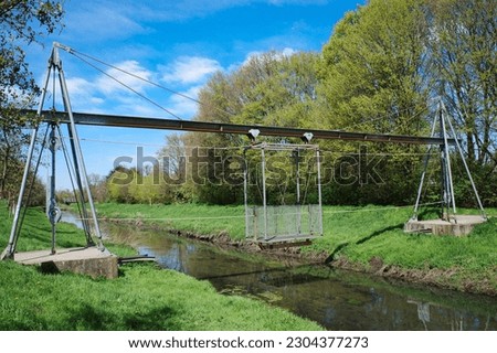 Cable car over a small stream in a rural setting