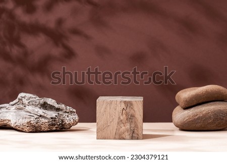 Abstract background from natural materials stone, tree for the presentation of a cosmetic product. Sun shade made of tropical leaves cosmetic wooden beauty display case