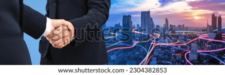 Double exposure of handshake between businessman with speed line glowing light trail surrounds the Smart city - Business success agreement, Immovable property concept. panoramic banner