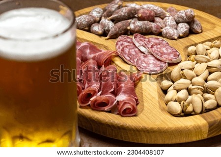 Sausages and pistachios and a glass of beer
