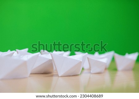 Boat shaped made of white paper on the table