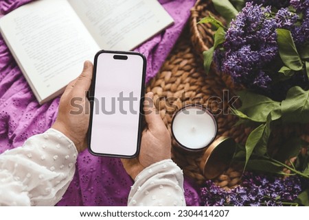 Phone in hands with isolated screen, space for text.