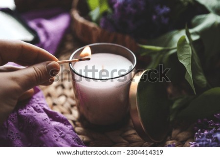 Girl lights a candle, aesthetic photo.