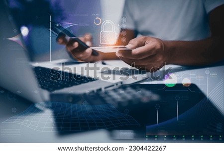 Business hands holding a credit card with mobile phone and laptop computer and Internet network security interface icons.