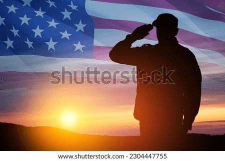 Silhouette of soldier saluting on a background of sunset or sunrise and USA flag. Close-up. Greeting card for Veterans Day, Memorial Day, Independence Day. America celebration.