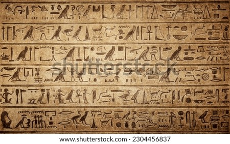 Old Egyptian hieroglyphs on an ancient background. Wide historical background. Ancient Egyptian hieroglyphs as a symbol of the history of the Earth.  Royalty-Free Stock Photo #2304456837