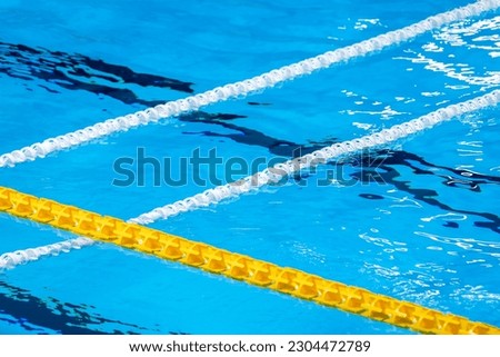 The view of an empty public swimming pool indoors. Lanes of a competition swimming pool. Horizontal sport theme poster, greeting cards, headers, website and app