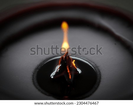 Candle close up picture showing the fire and flame in the  dark background