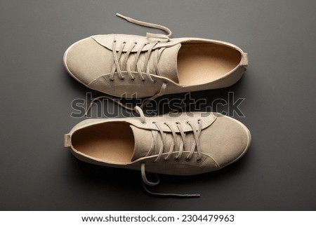 Men's sneakers on gray background. Stylish sports casual shoes. Creative minimalist layout with footwear.
