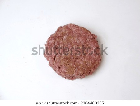 Studio shot of hamburger patty on white background. Copy space