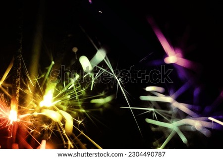 Close up shot of ignite handheld sparkler as background Royalty-Free Stock Photo #2304490787