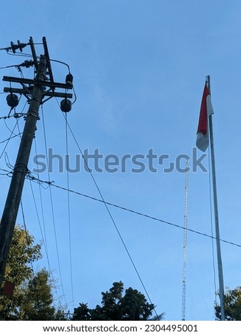 electric poles and red and white flags