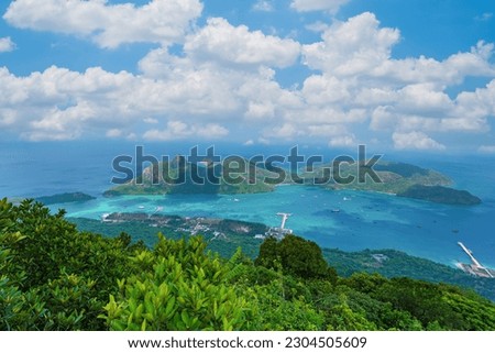 Top view Panoramic coastal Con Dao island view from above, with waves, coastline ,clear sky and road, blue sea and mountain. New passenger port of Con Dao. Royalty-Free Stock Photo #2304505609