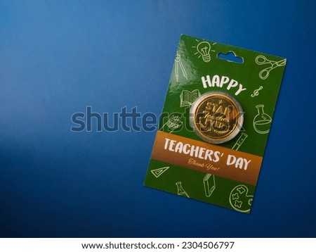 Top view Happy teacher day gift on a blue background with copt space.