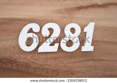 White number 6281 on a brown and light brown wooden background.