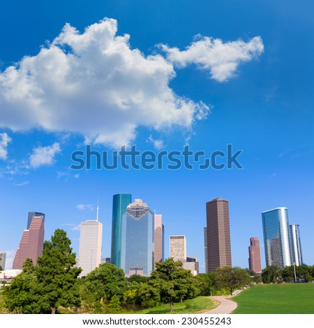 Houston skyline sunny day with park turf under blue sky at Texas USA