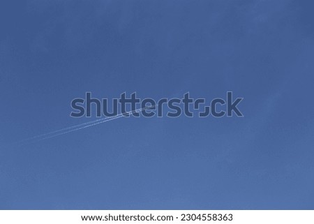 Take pictures of airplanes flying in the blue sky and white clouds