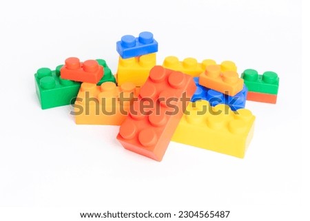 pile plastic toy blocks on white background Royalty-Free Stock Photo #2304565487