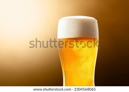 Beer, liquor that looks delicious with bubbles popping in the glass Royalty-Free Stock Photo #2304568065