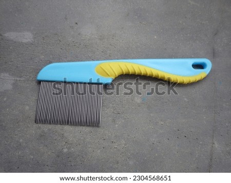 Comb to clean hair from lice. This comb is light blue with a slight yellow line.
