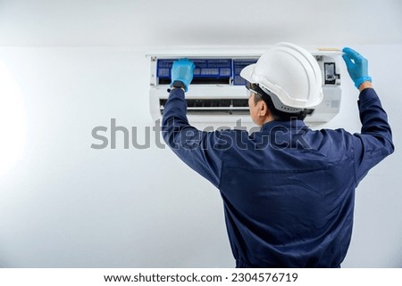 Air conditioner technician, repair service, install air conditioner in the house Are going to repair and take care of filling air conditioners in homes and buildings. Royalty-Free Stock Photo #2304576719