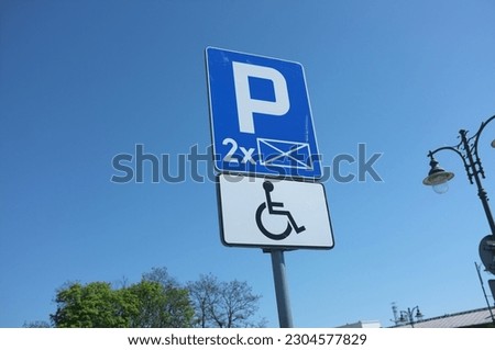 blue sign painted on parking space  for disability wheelchair