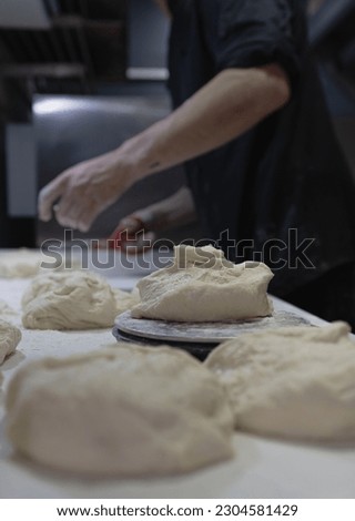 Pizza chef makes a pizza by molding the dough