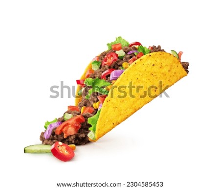Chopped toppings spilling out of a Mexican taco isolated on a white background