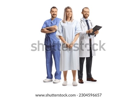 Female patient in a hospital gown standing in front of doctors isolated on white background Royalty-Free Stock Photo #2304596657