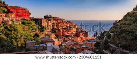Traditional colorful houses above the Mediterranean Sea in the romantic old town of Manarola in Cinque Terre, Italy on a sunny day Royalty-Free Stock Photo #2304601151