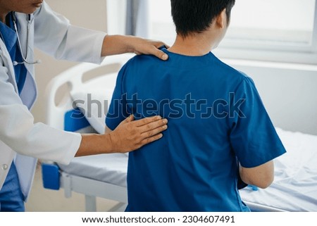 Doctor consulting with patient Back problems Physical on the bed in clinic therapy concept 
 Royalty-Free Stock Photo #2304607491