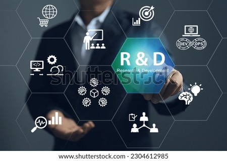 The businessman pointing to Research and development or R and D to remine new product development process explains the importance of each step of work before new product can be released to the market. Royalty-Free Stock Photo #2304612985