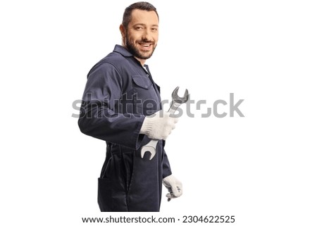 Car mechanic holding a wrench and looking over shoulder isolated on white background Royalty-Free Stock Photo #2304622525