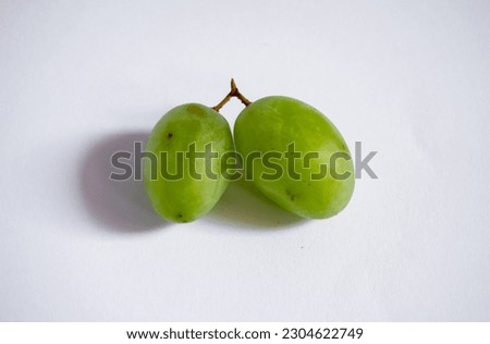 Fresh green grapes picked from the tree on a white background