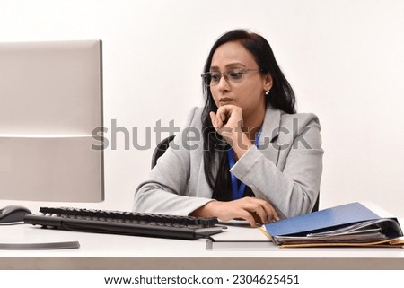 Portraits of young indian businesswoman working on computer isolated on white background
