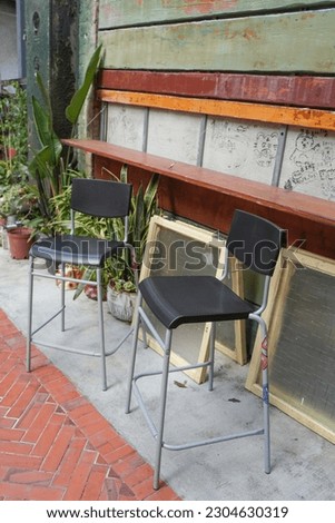 
Street scene documentary photography in Tainan, Taiwan - Black high chair next to the old house