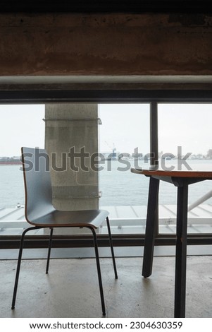 Street scene documentary photography in Tainan, Taiwan - drinking coffee while looking at the port outside the window