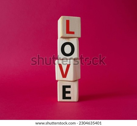 Love symbol. Concept word Love on wooden cubes. Beautiful red background. Business and Love concept. Copy space.