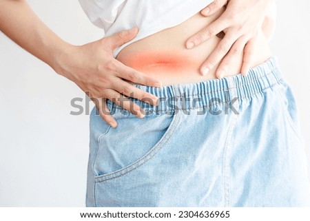 Surgical scars on a woman's abdomen on a white background.