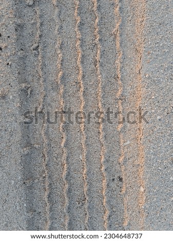 car tire tracks on the beach sand