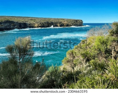 Scenic view from Wattamolla on the coastal walking trail to Providential Point lookout with ocean view and the headland on the opposite side of the cove in Royal National Park, NSW, Australia. Royalty-Free Stock Photo #2304663195