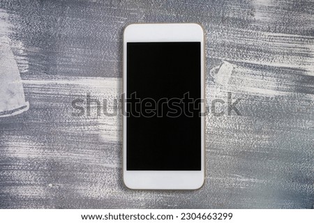 Modern phone with a blank screen on the desk