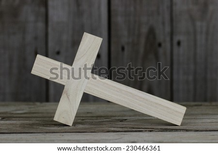 Close-up fallen wooden cross with rugged wood background
