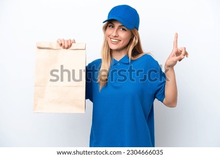 Young Uruguayan woman taking a bag of takeaway food isolated on white background pointing up a great idea