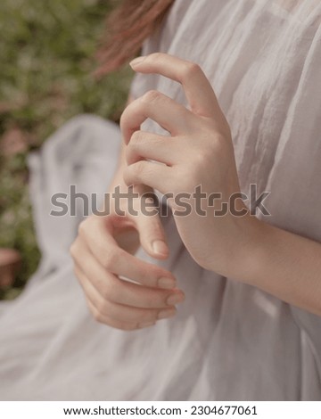 A close-up photo capturing the hands of a young women.