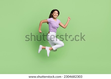 Full length body cadre of running vietnamese attractive funny lady hurry jumping deadline motivation isolated on green color background